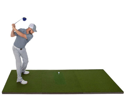 Golf mat with an individual in the middle of a golf swing but golf ball on mat.